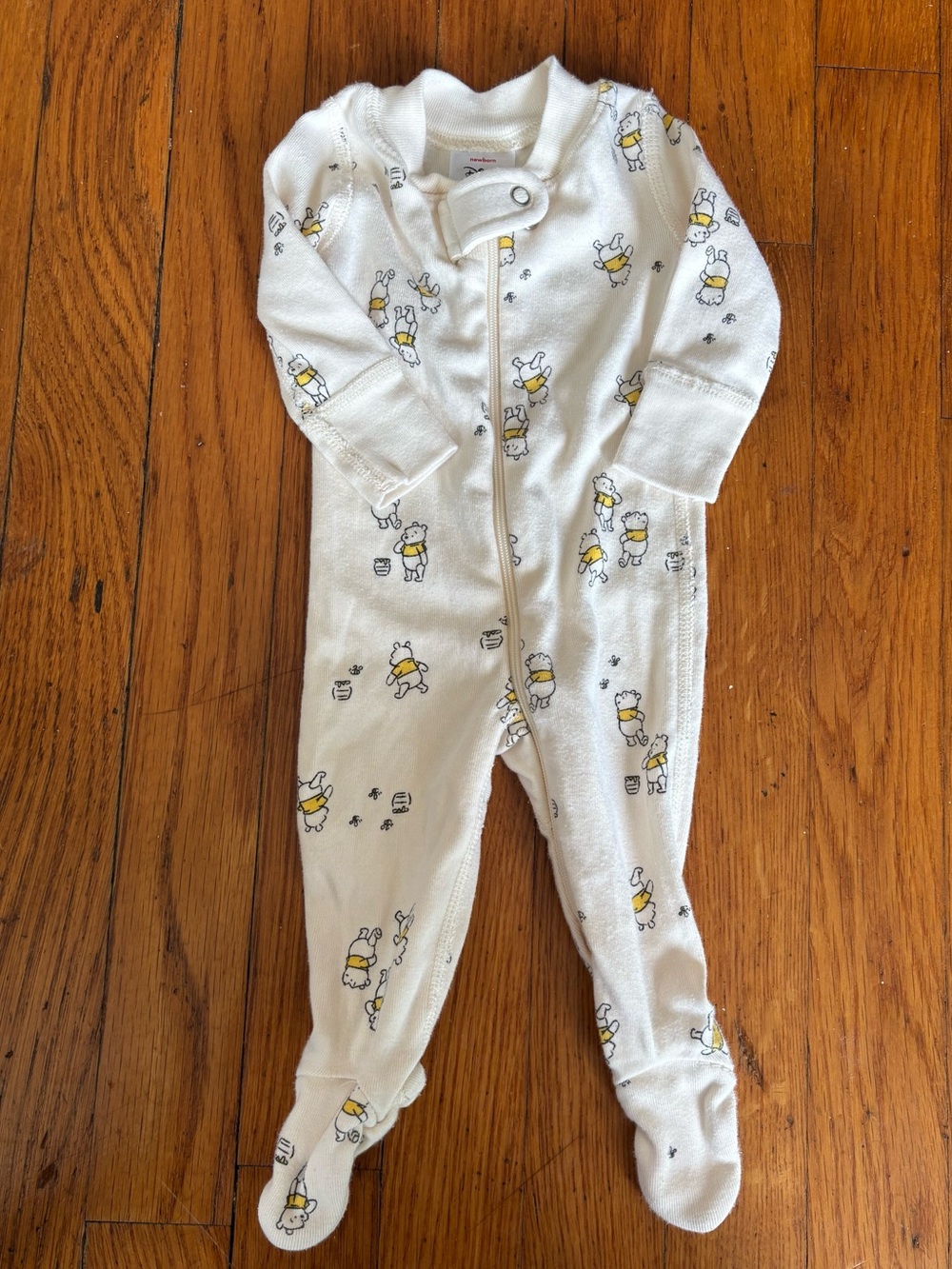 Hanna Andersson Cream Footed One-Piece with Winnie the Pooh.